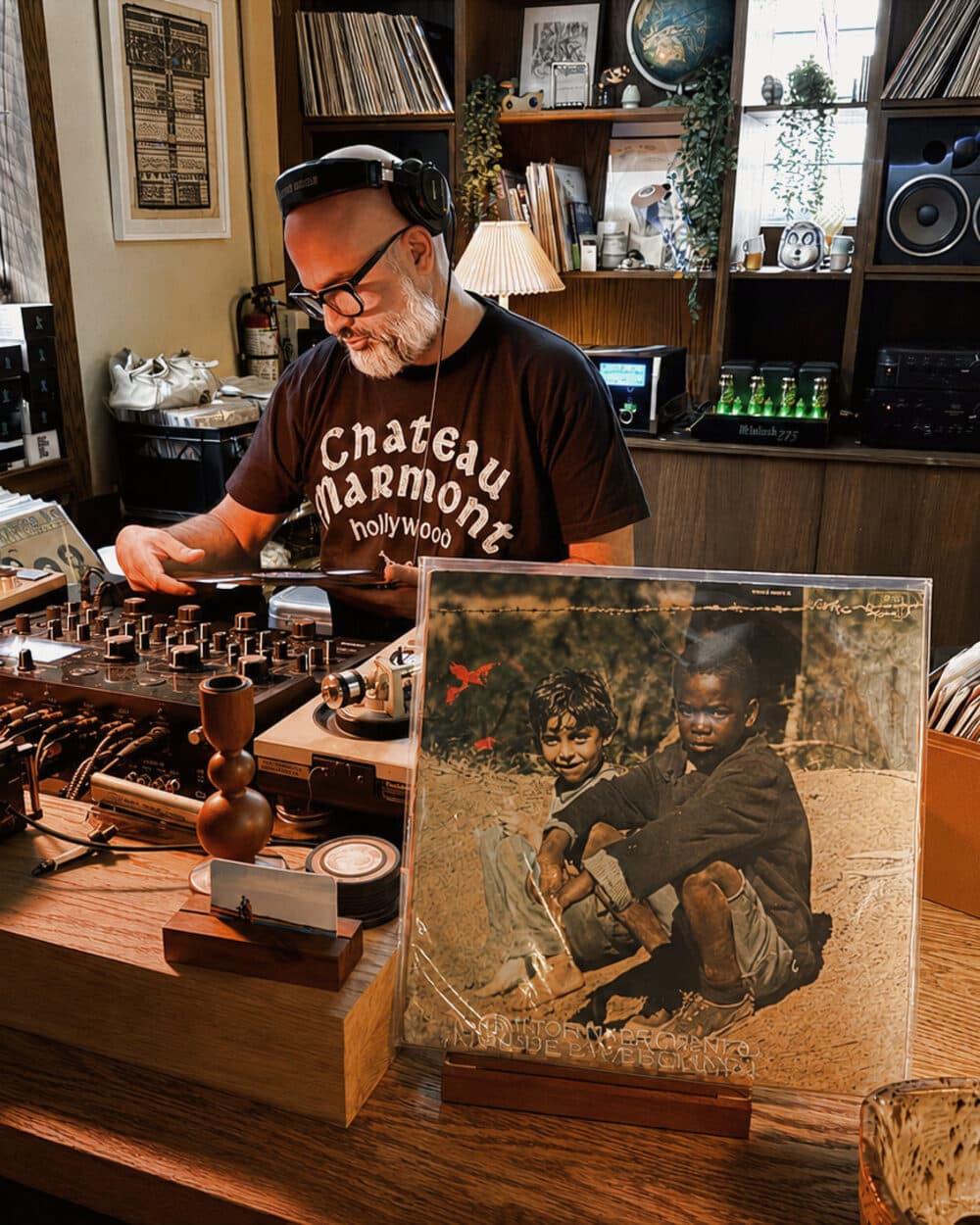 Steven Fernandez behind the turntables at 915 Dupont, Milton Nascimento & Lô Borges' Clube da Esquina propped beside the decks